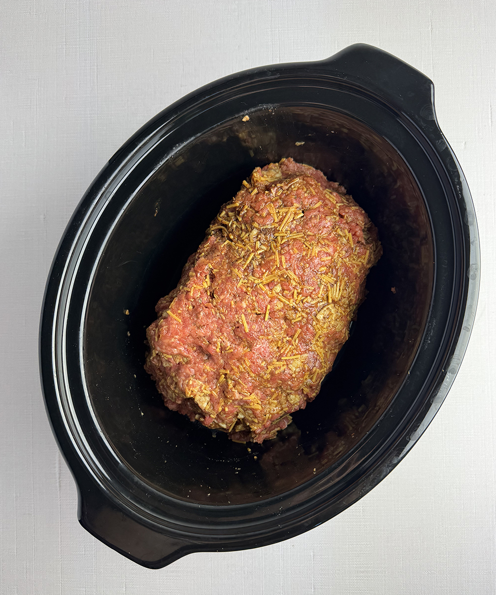 Taco meatloaf in a slow cooker ready to be cooked.