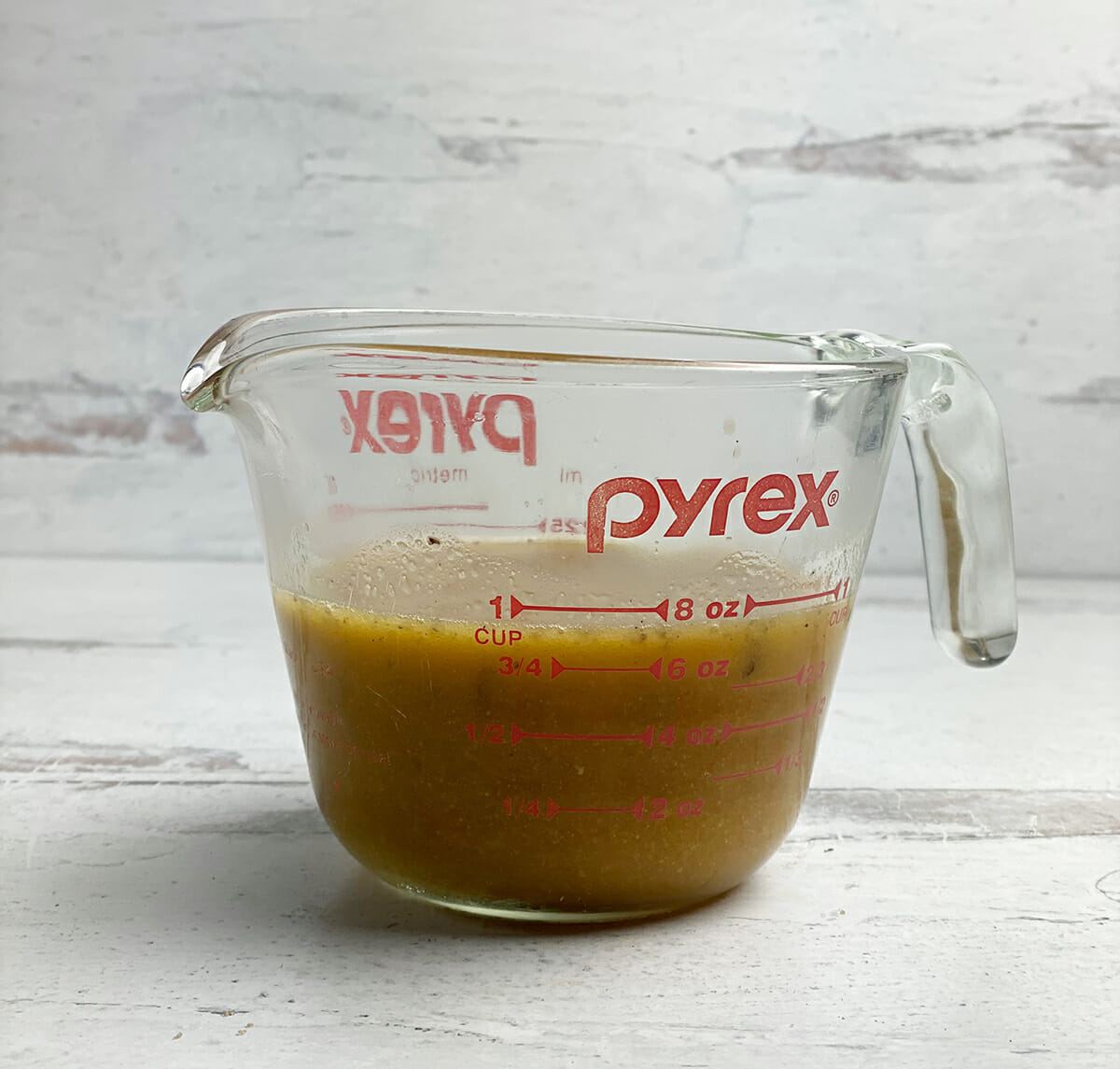 measuring cup with chicken diane sauce