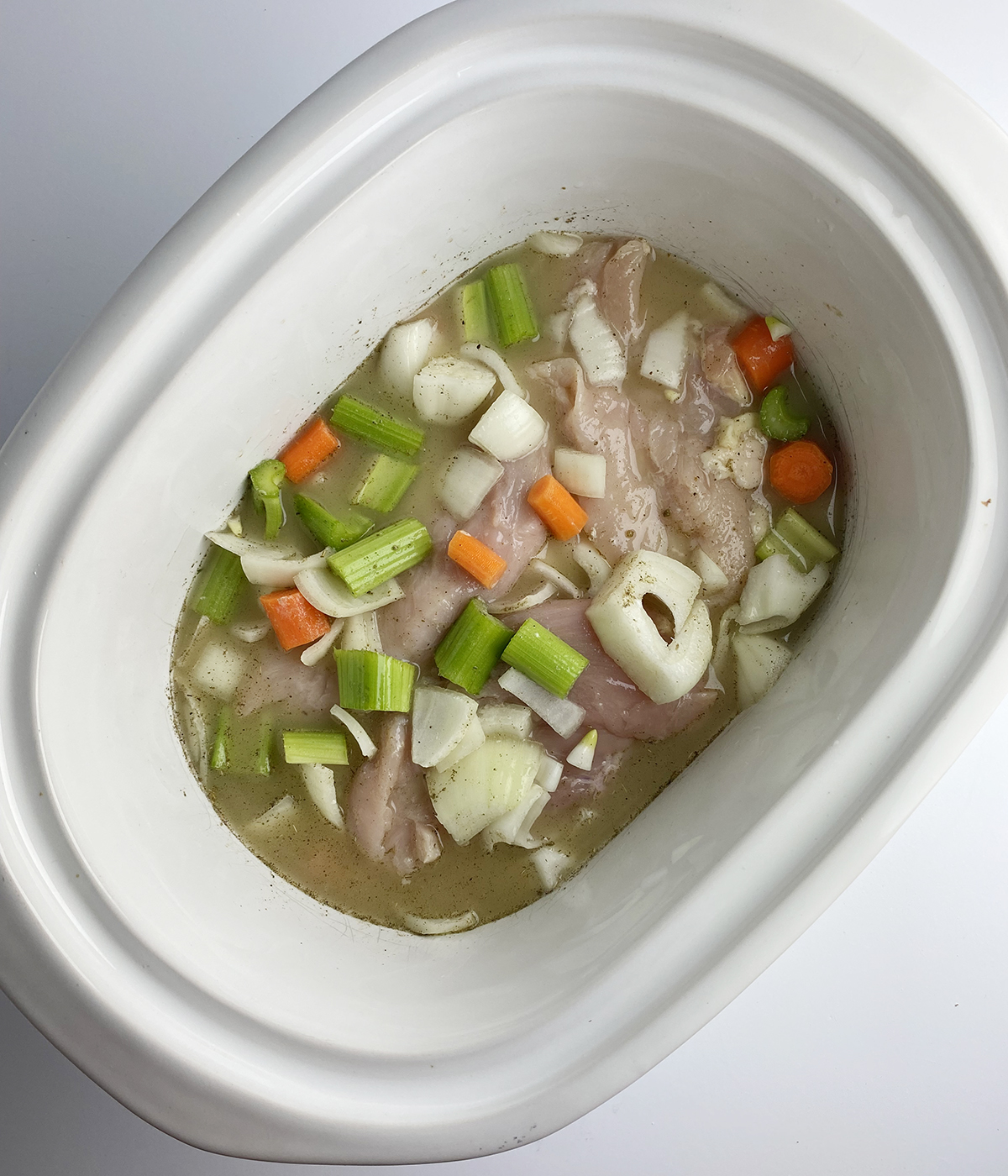 Chicken and vegetables in a slow cooker.