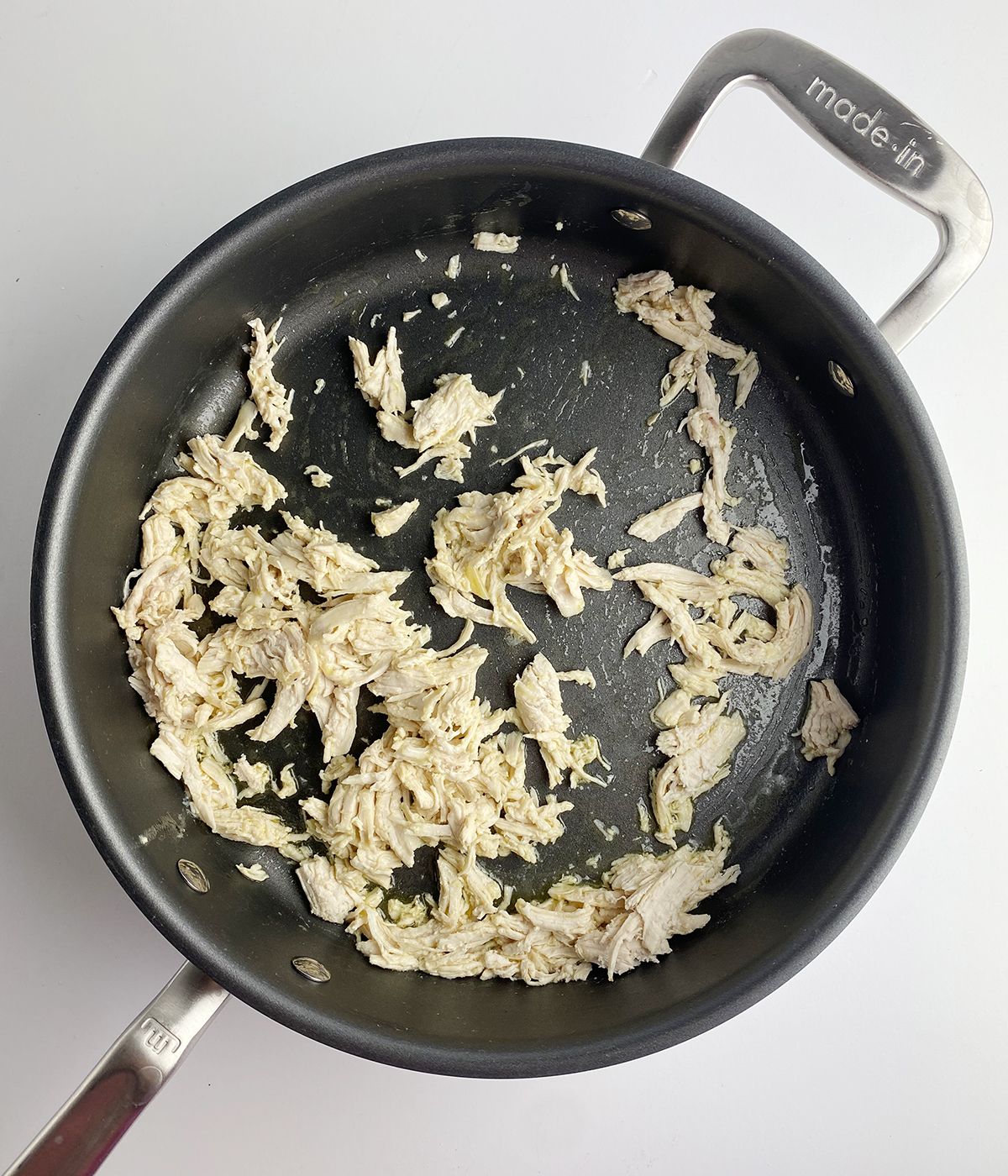 Chicken warming in a skillet.