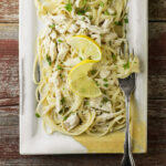 Lemon chicken pasta on a plate with a fork.