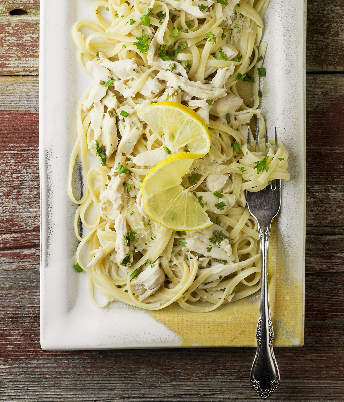 Lemon chicken pasta on a plate with a fork.