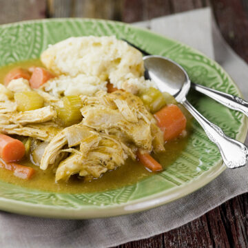 Slow cooker chicken and dumplings on a plate.