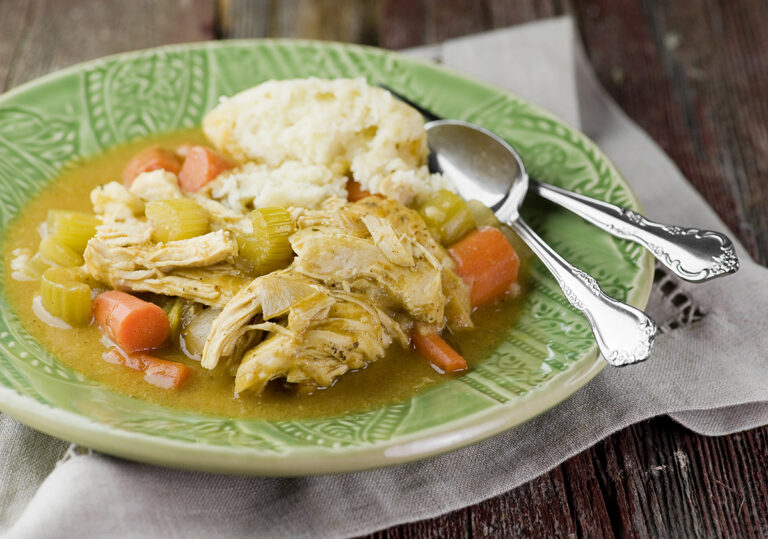 Slow cooker chicken and dumplings on a plate.