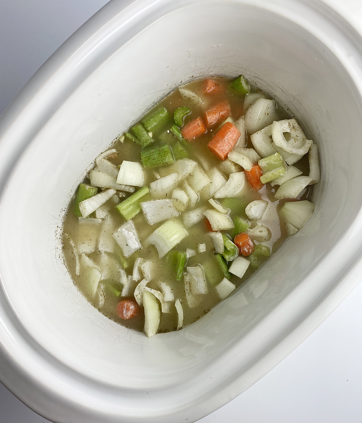 Vegetables and chicken broth ina slow cooker.
