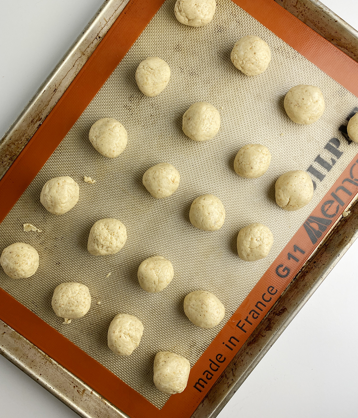 Rolled out rum balls on a cookie sheet.