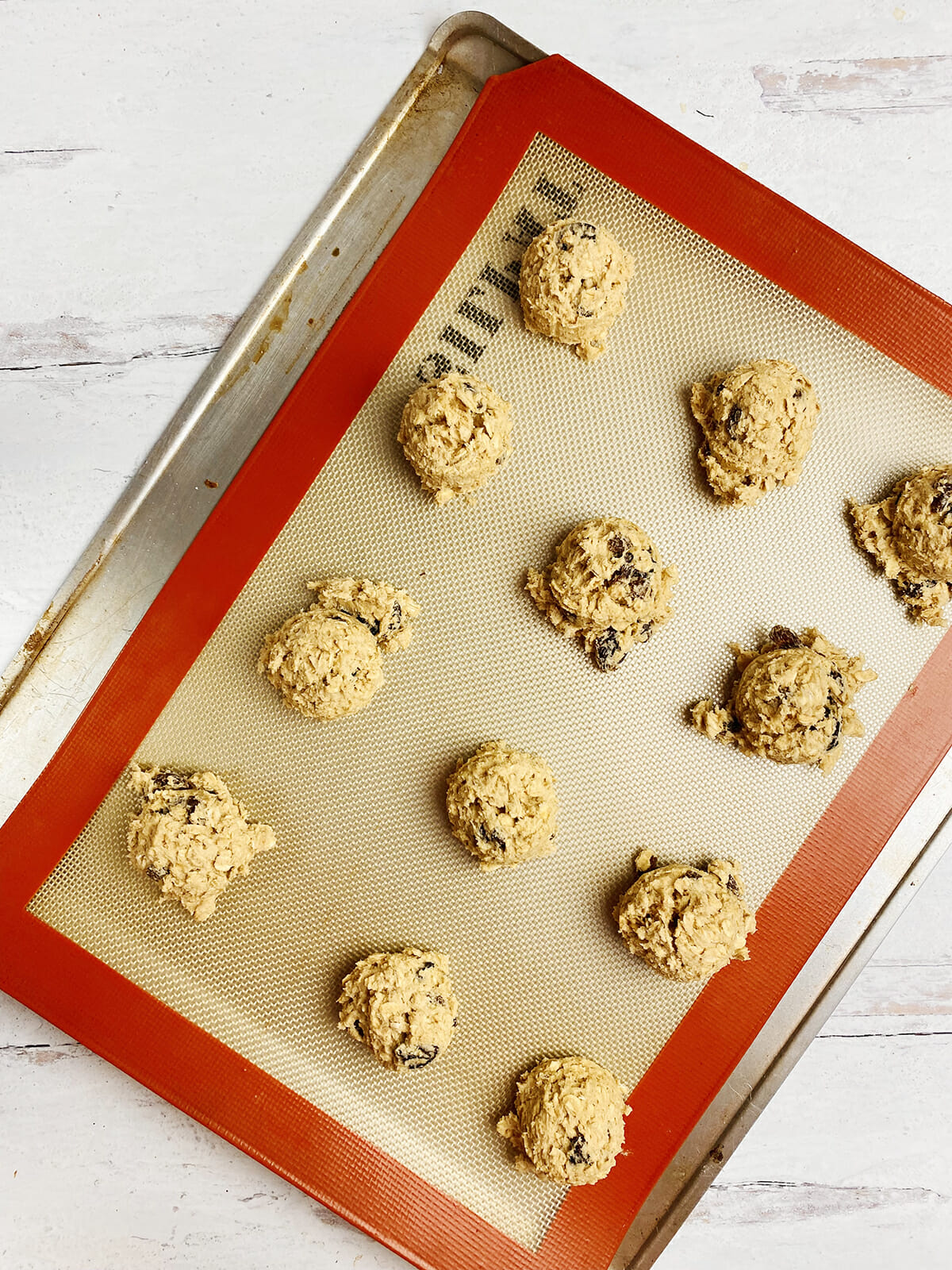 Cookie dough on a lined cookie sheet ready for the oven.