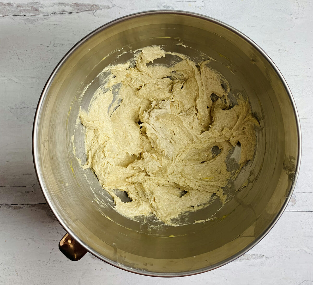 Mixed butter sugar and eggs in a mixing bowl.