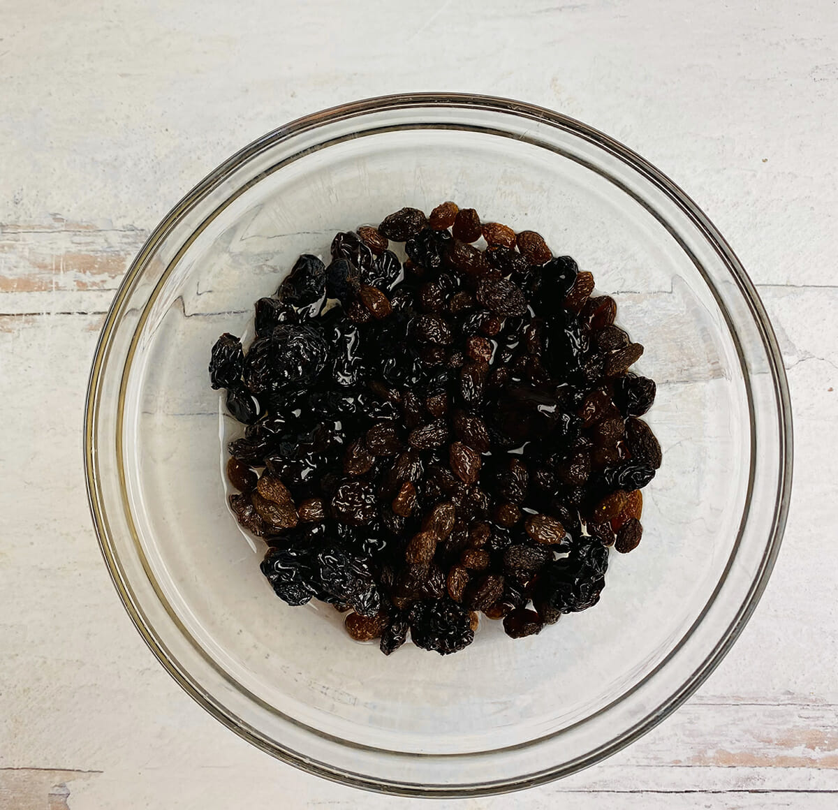 A bowl of raisins soaking in rum.