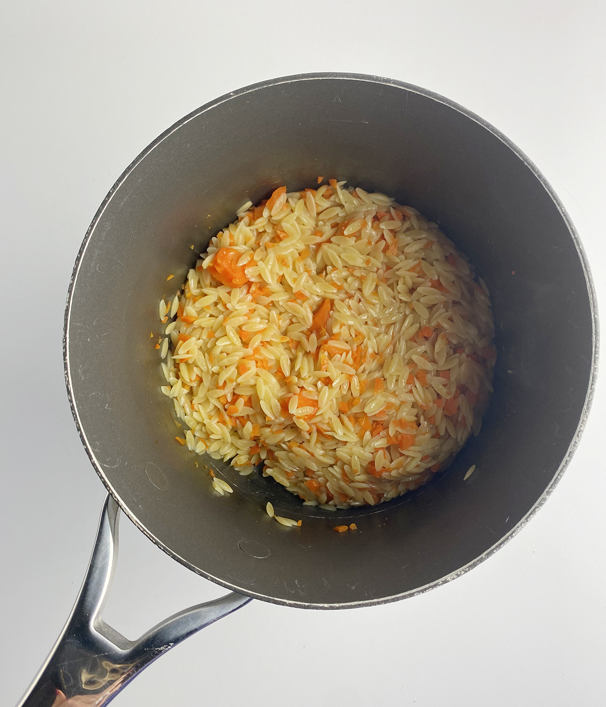 Cooked pasta with veggies in a pot.