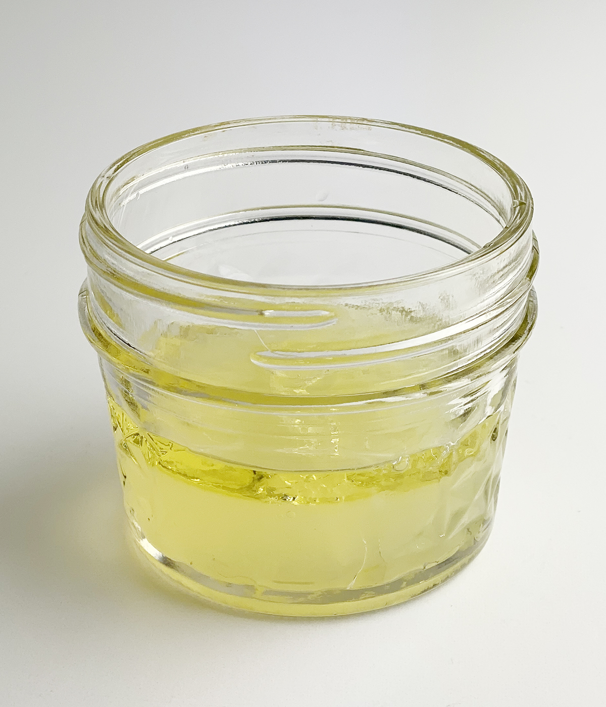 Lemon olive oil dressing in a jar.