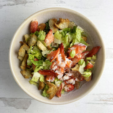 Lobster Caesar Salad in a serving bowl.