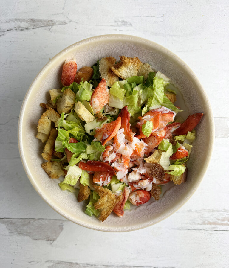 Lobster Caesar Salad in a serving bowl.