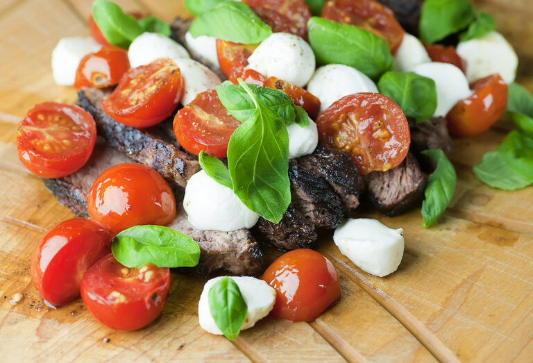 Steak Caprese on a cutting board.