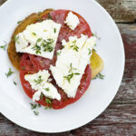 Tomato feta sandwich on a plate.