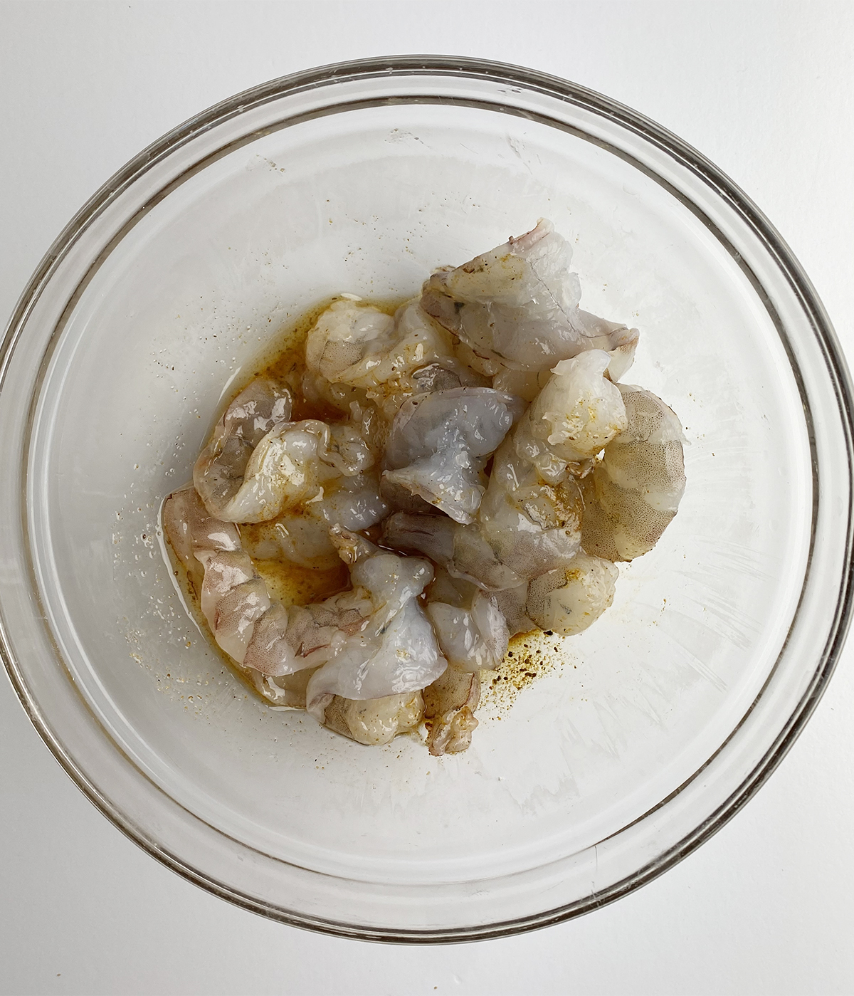 Shrimp marinating in a bowl.