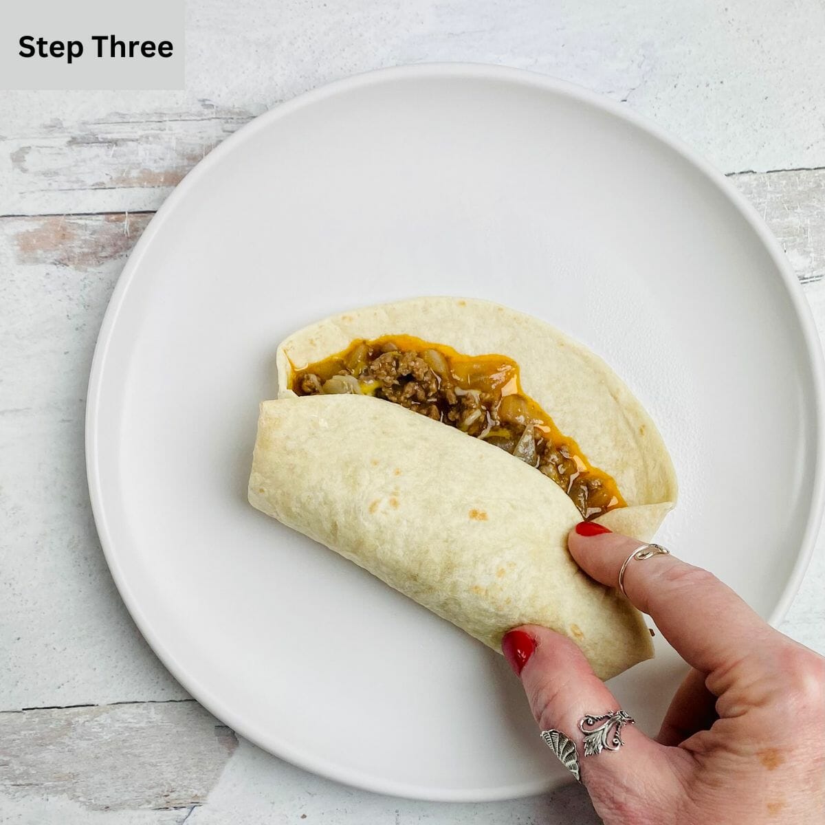 Taco wrap folding on a plate.