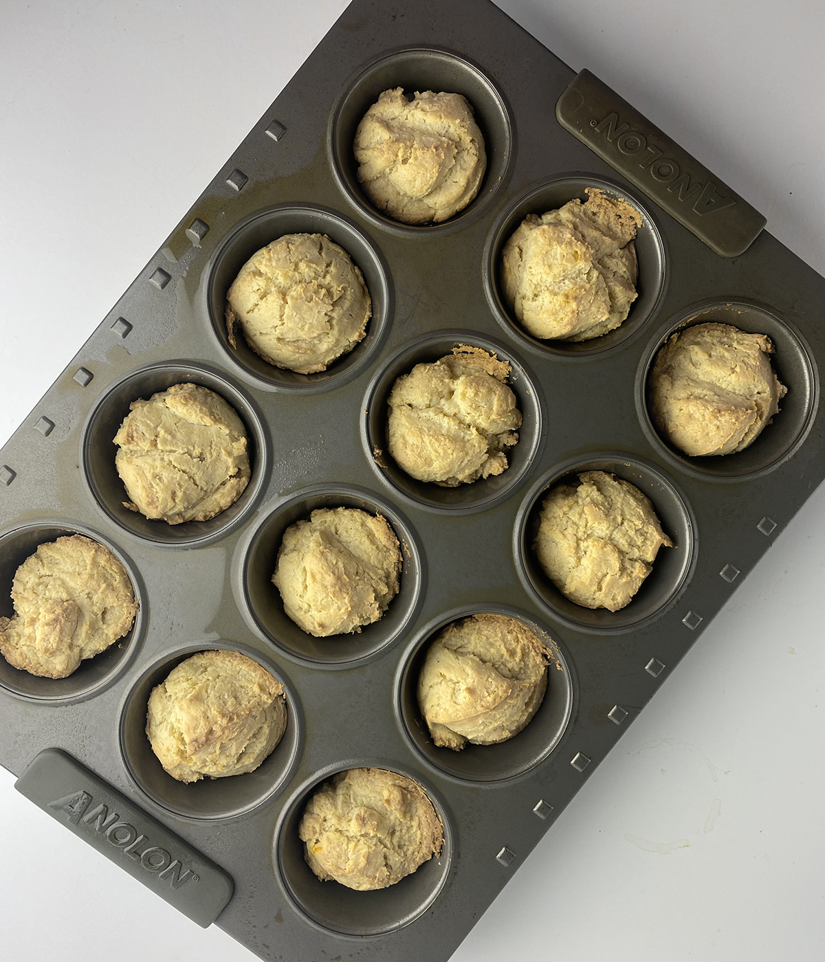Butter biscuits cooling in a muffin tin.