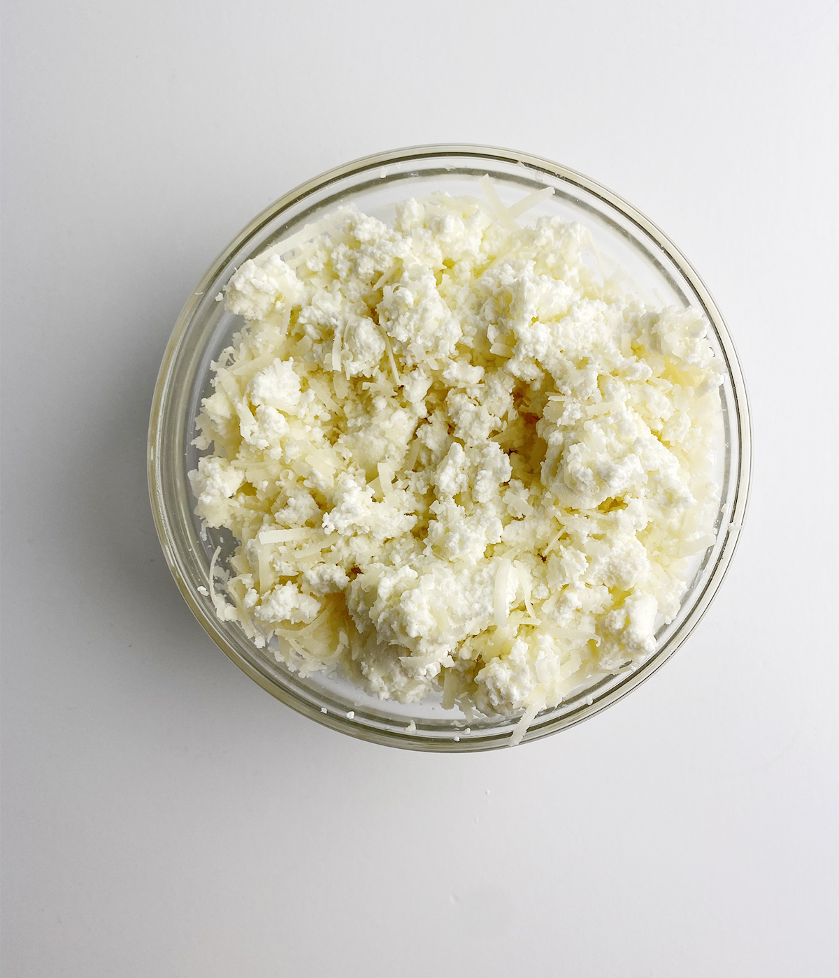 Ricotta and parmesan cheese mixture in a bowl