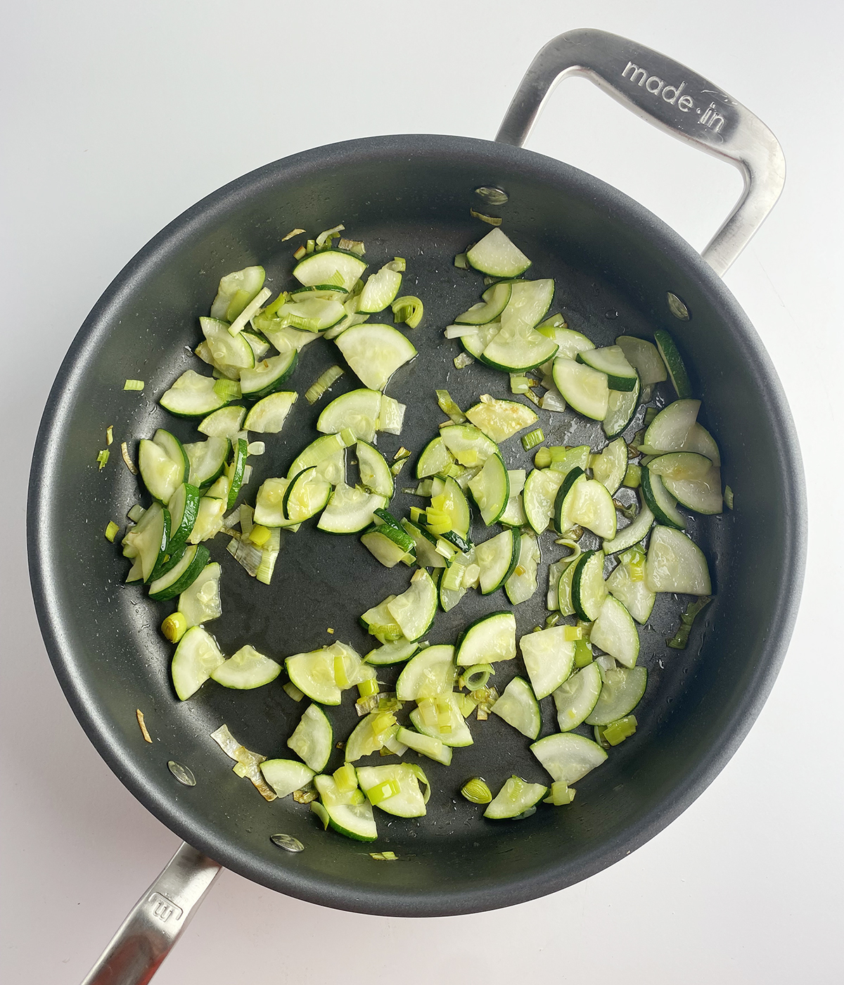 Sauteed zucchini in a skillet.