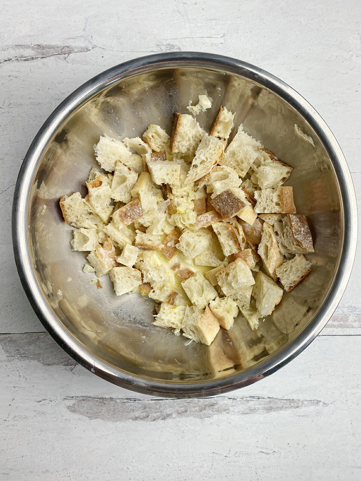 Grilled cheese bake bread soaking in milk in bowl.