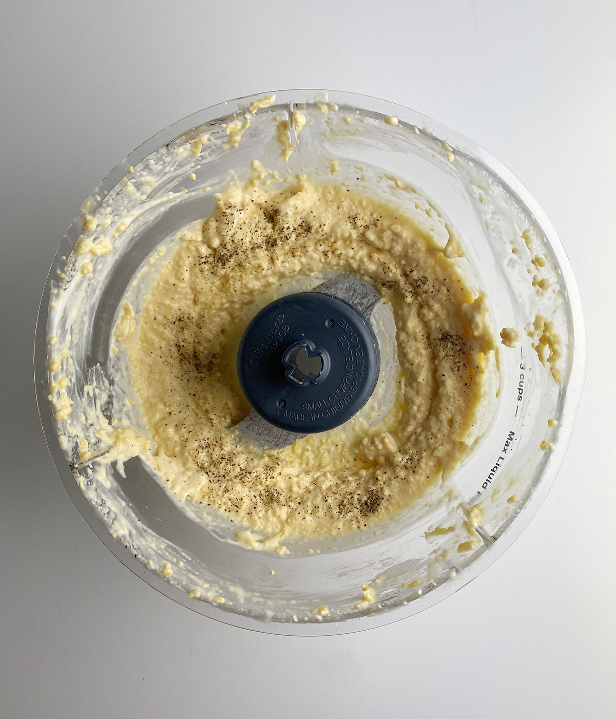 Cheddar cheese spread in a food processor.