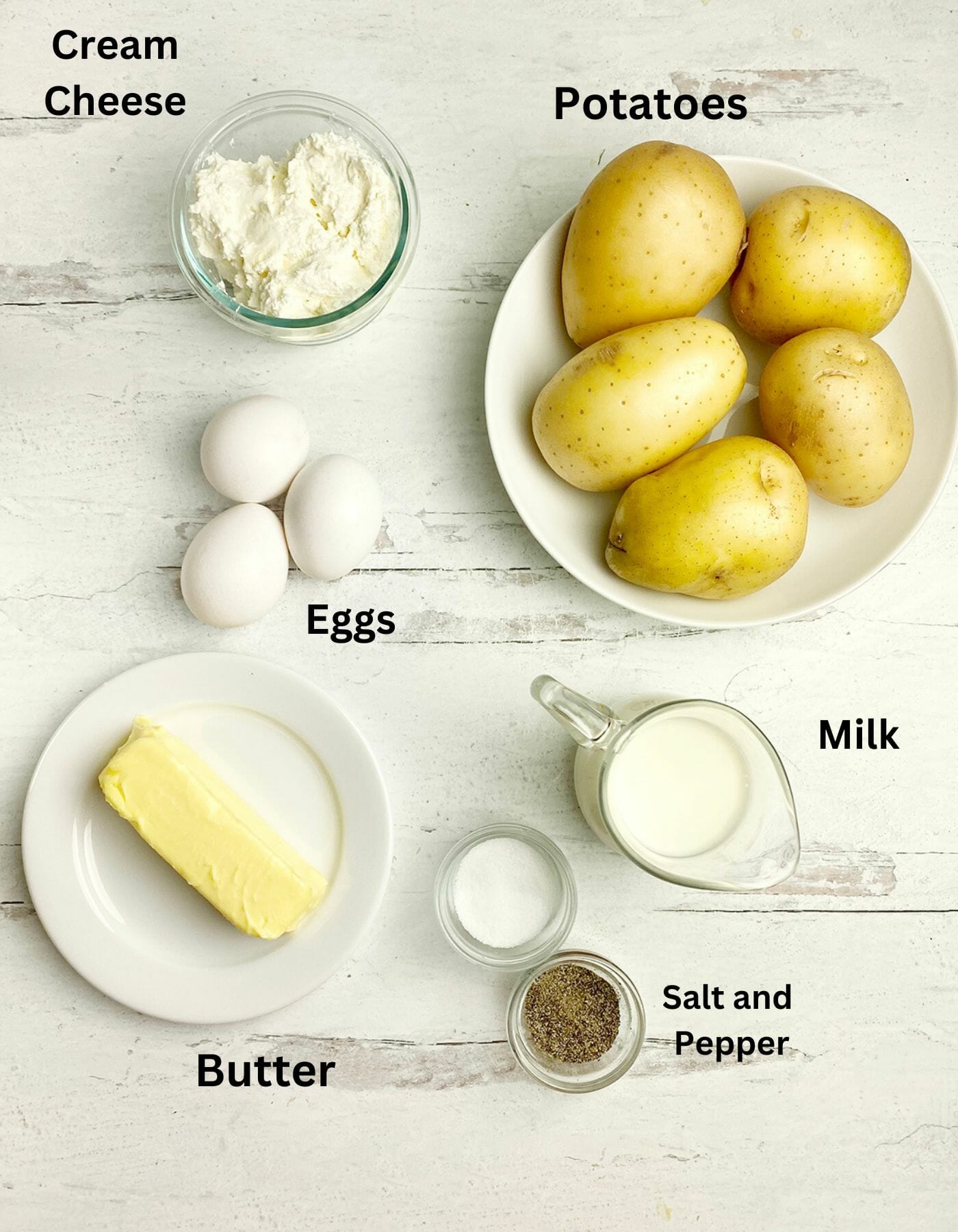 Baked mashed potatoes ingredients on a wooden counter.