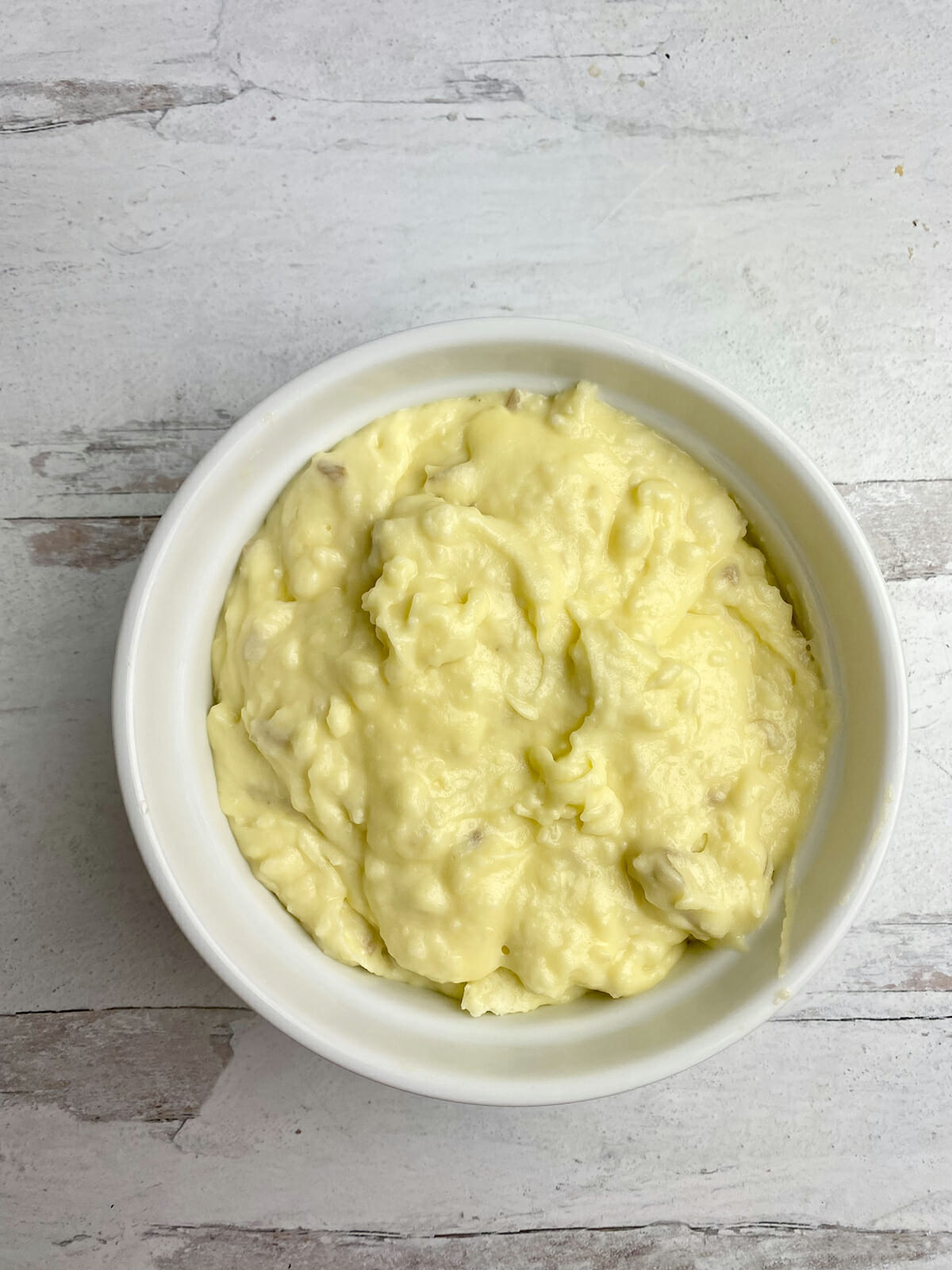 Baked mashed potatoes in a casserole ready for the oven.