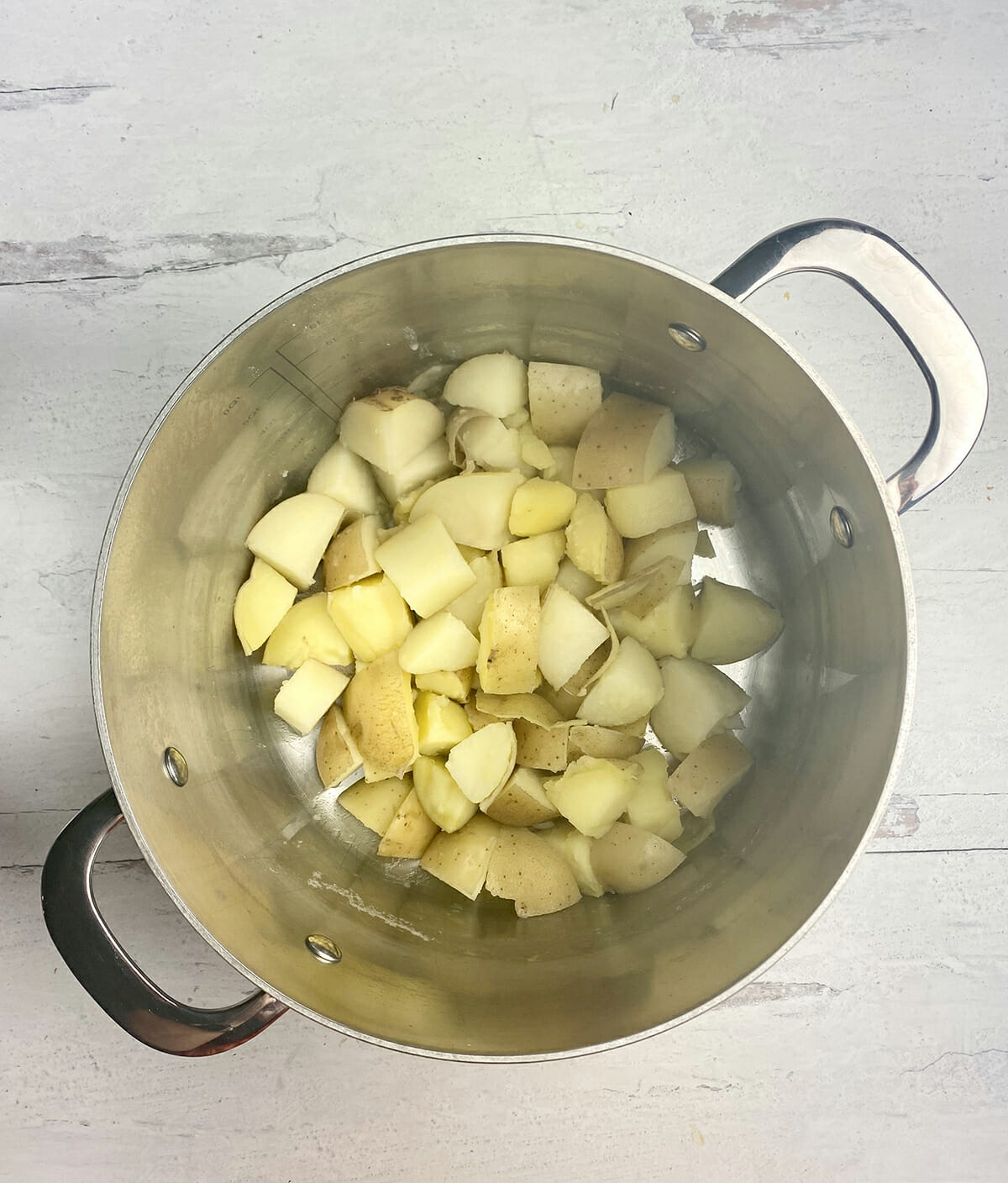 Cooked diced potatoes in a pot.