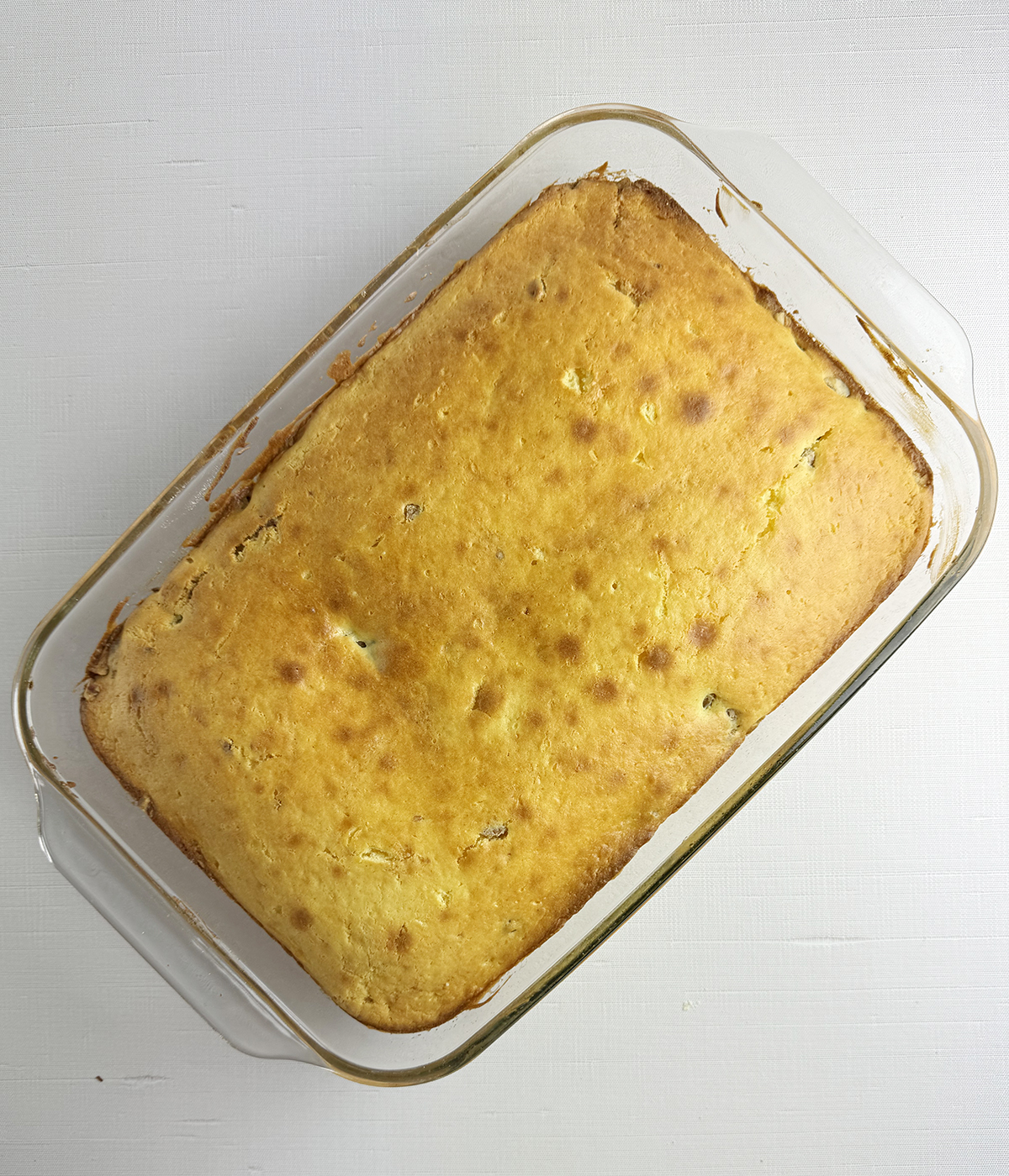 Baked honeybun cake in a pan.