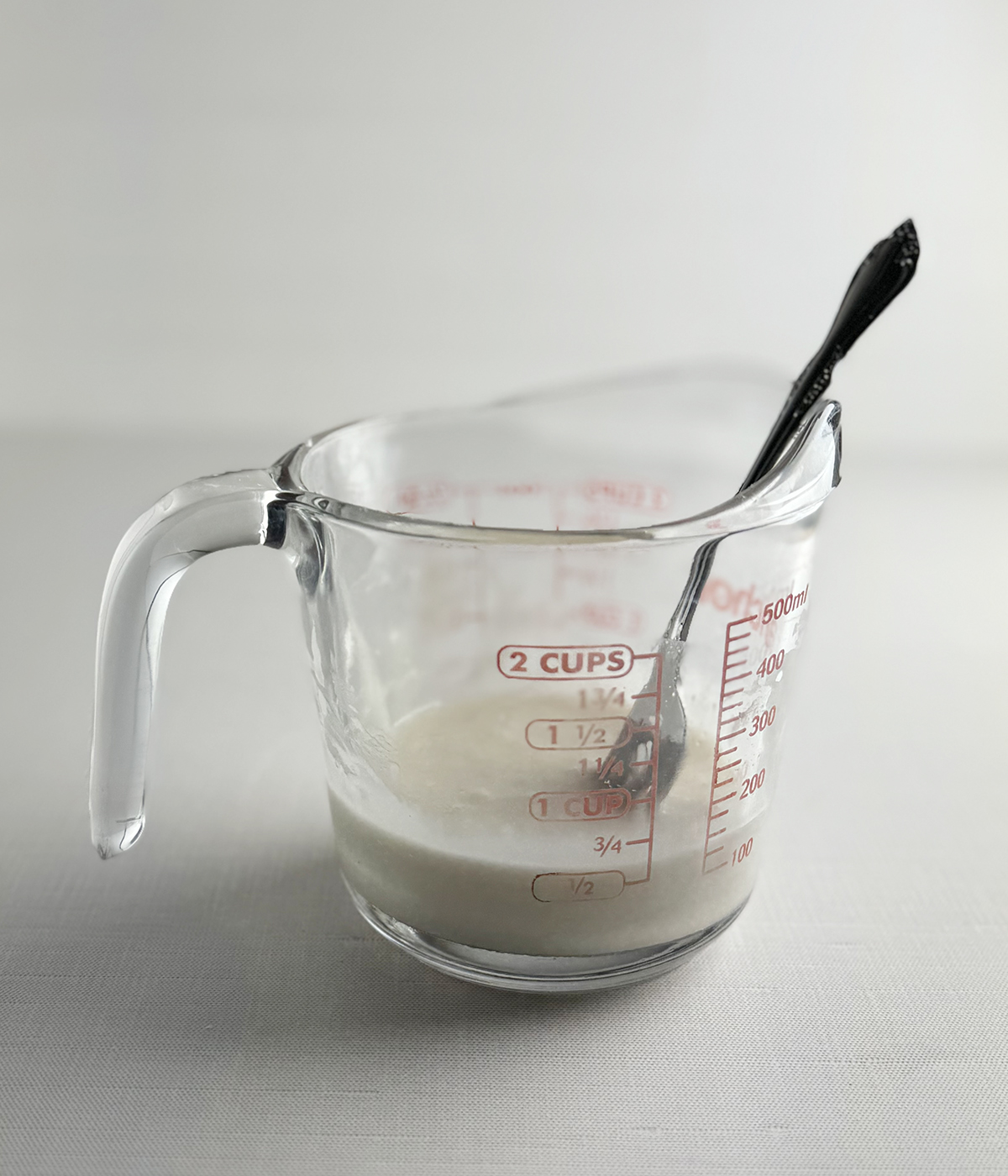 Vanilla glaze in a measuring cup.