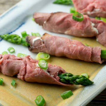 Horseradish asparagus roast beef roll-ups on a platter.