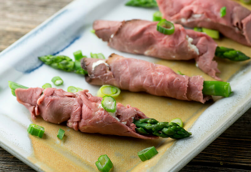 Horseradish asparagus roast beef roll-ups on a platter.