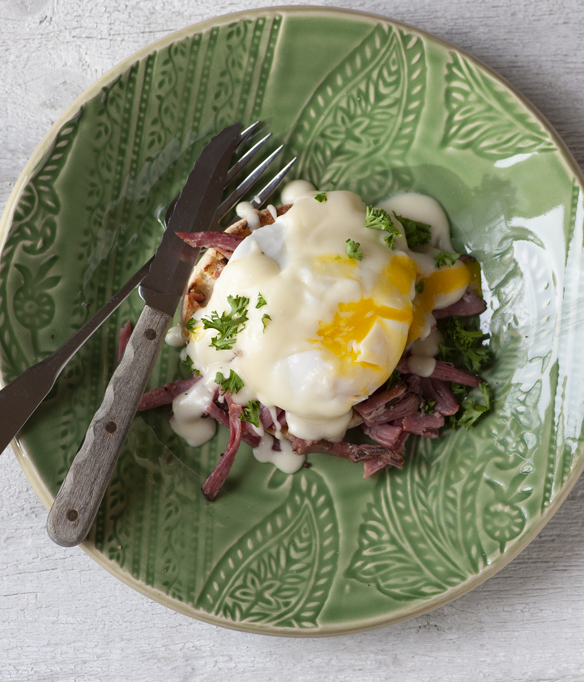 Irish eggs benedict on a plate with a fork and knife.