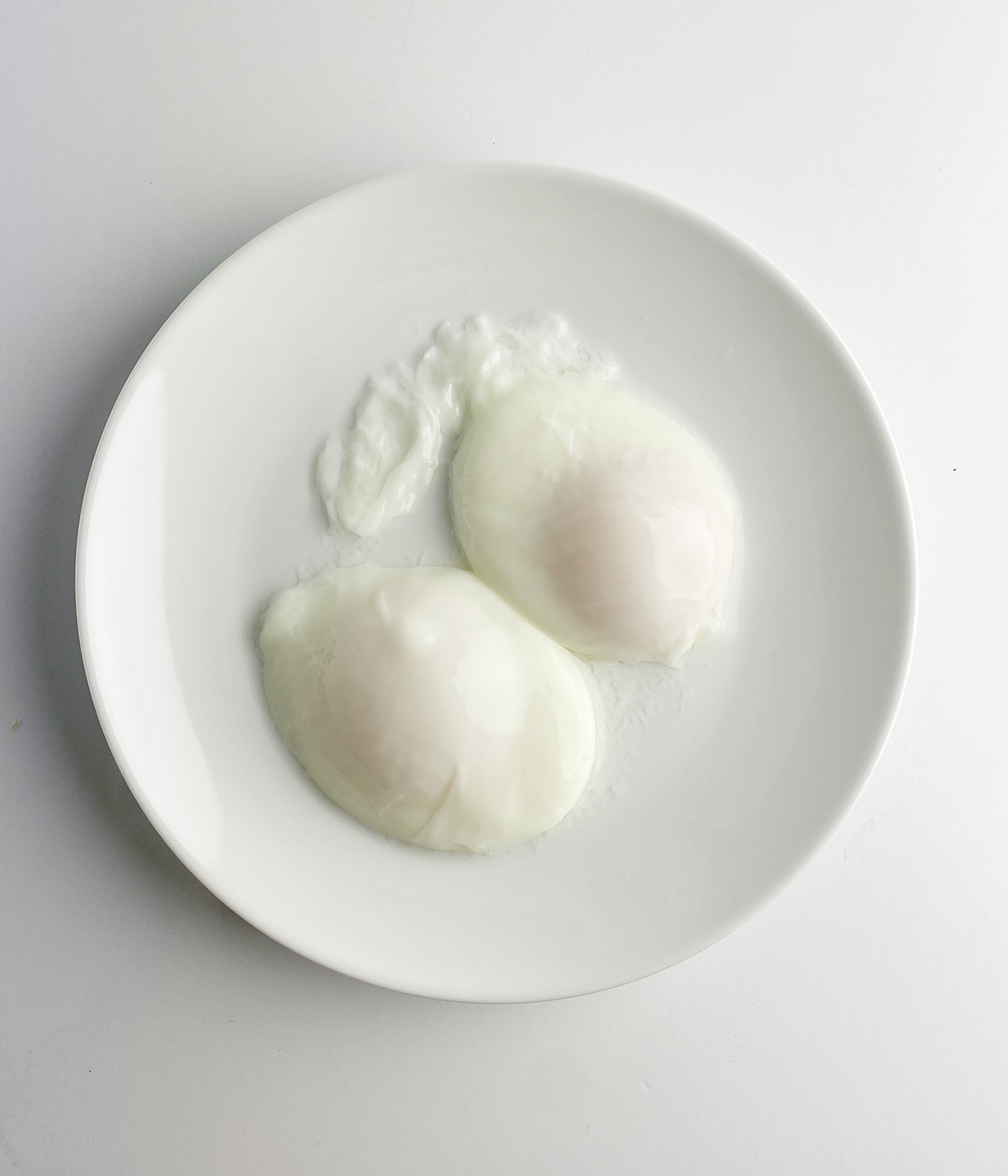 Two poached eggs on a plate.