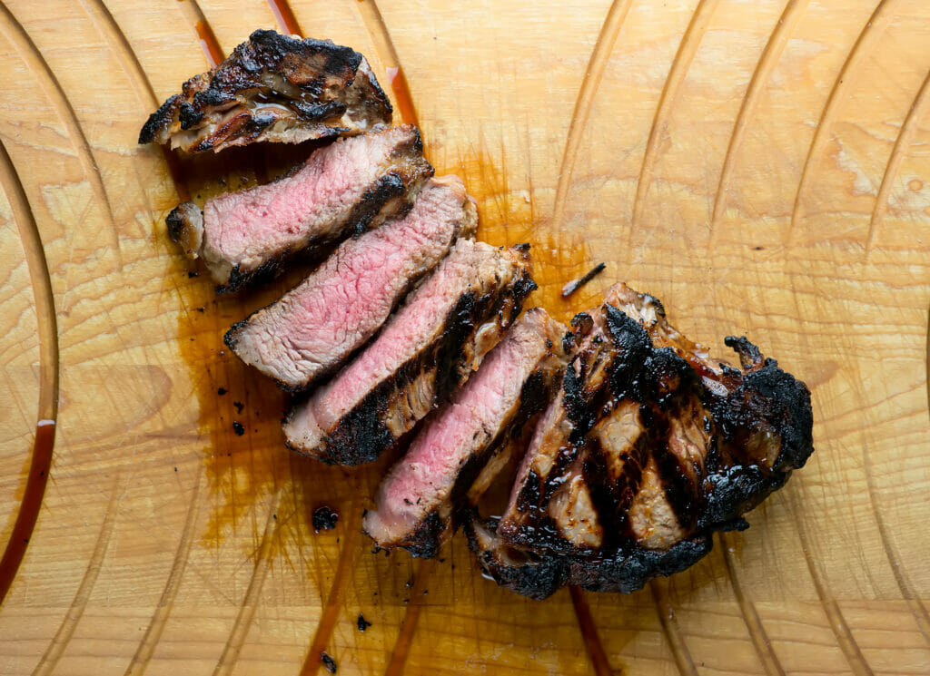 Buttermilk Steak sliced on a cutting board.