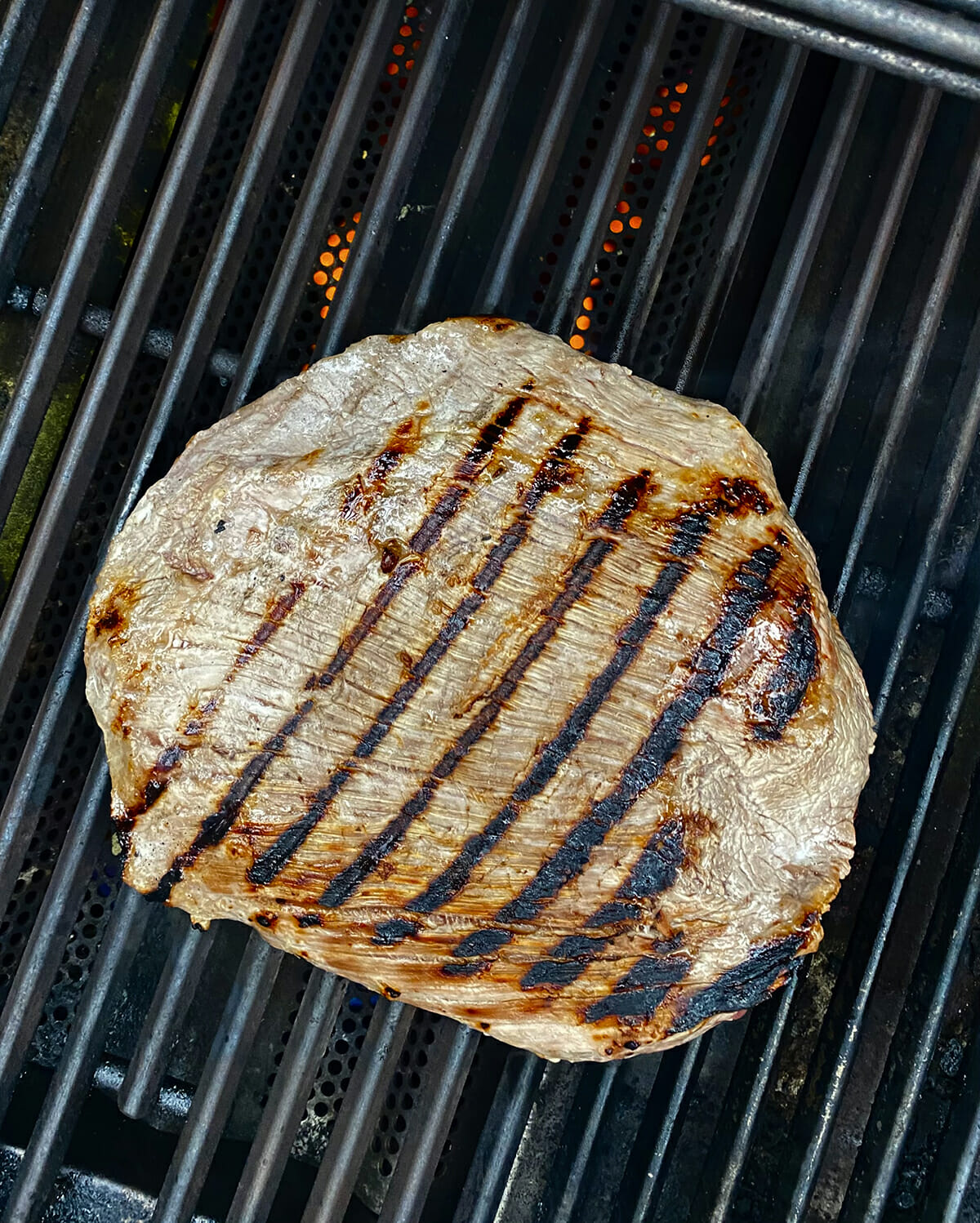 Buttermilk steak cooking on the grill.