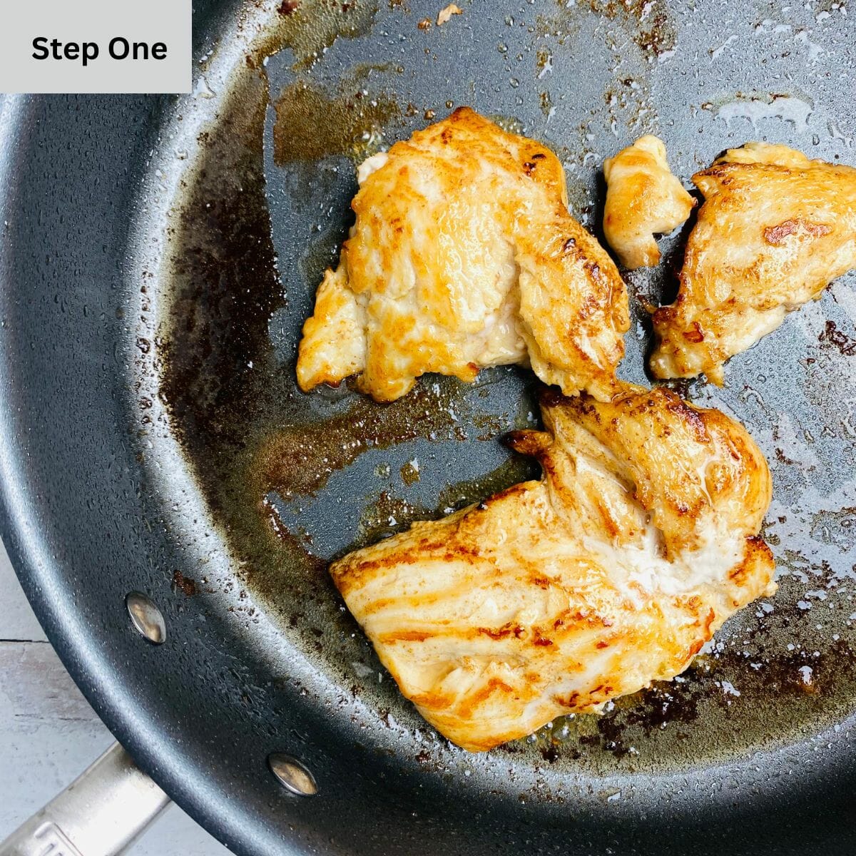 Chicken sauteed in a skillet.