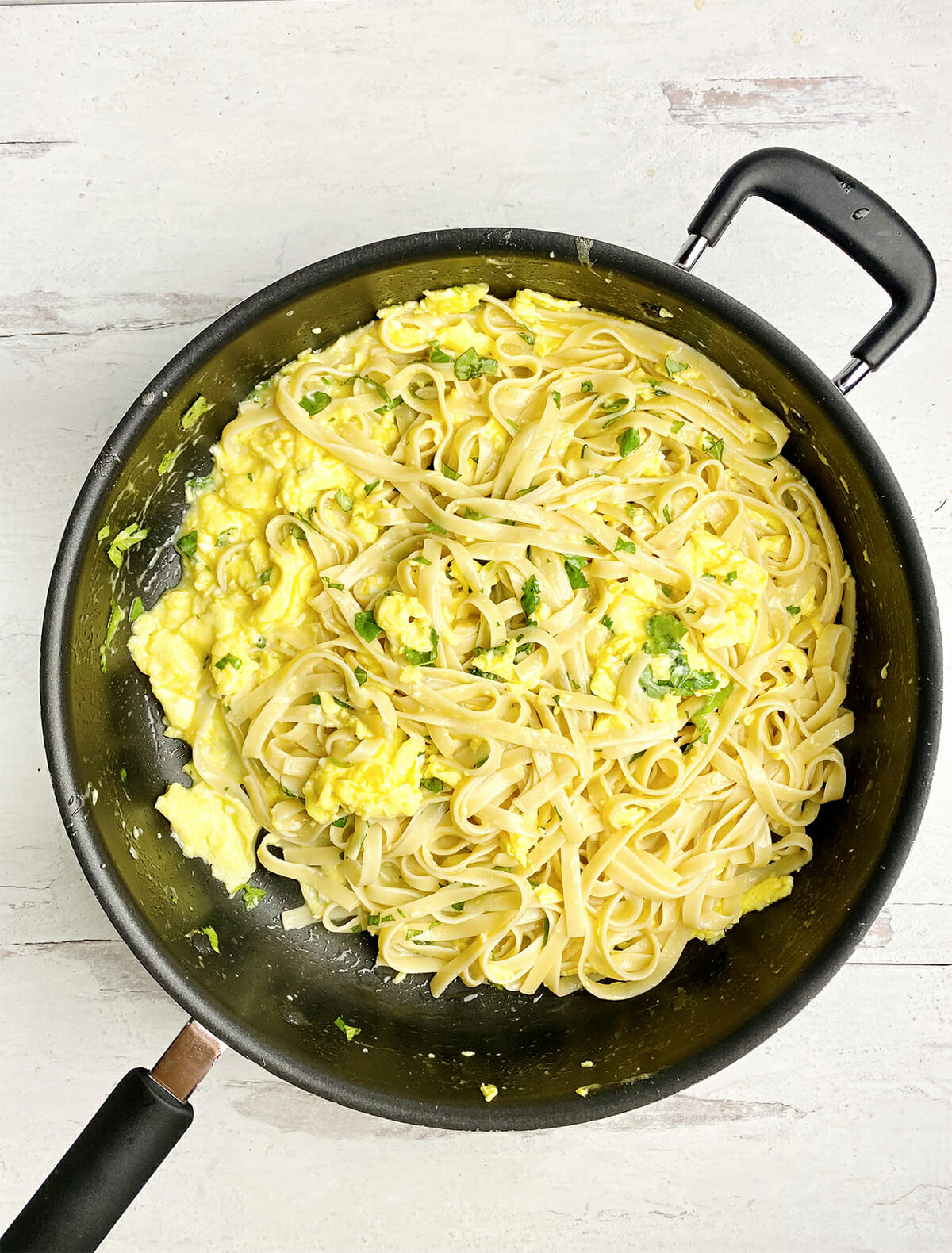 Pasta with buttered egg sauce in a pan.