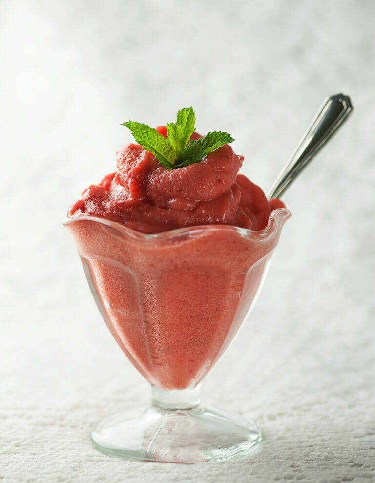 Strawberry Peach Sorbet in an ice cream glass.