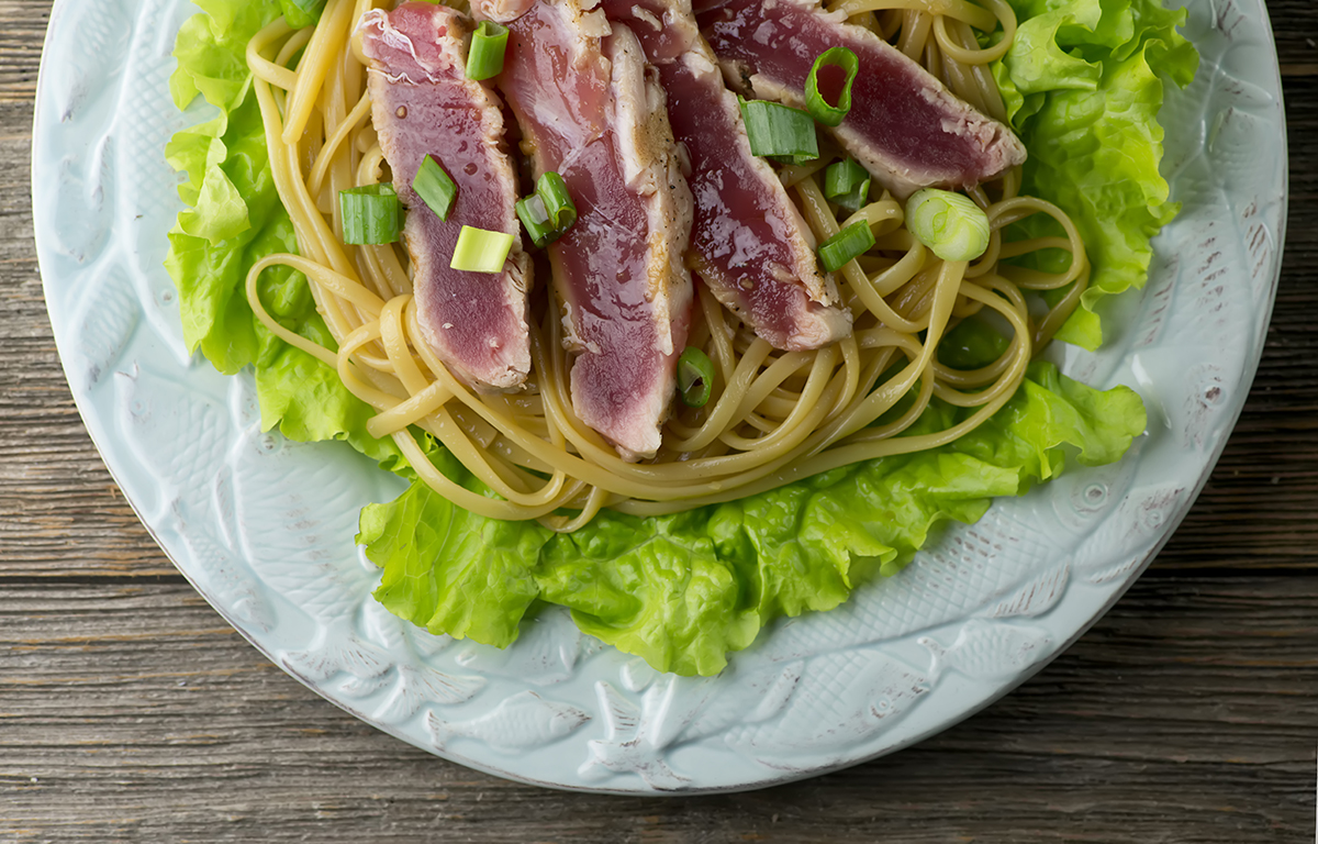 Grilled tuna with sesame noodles on a plate.