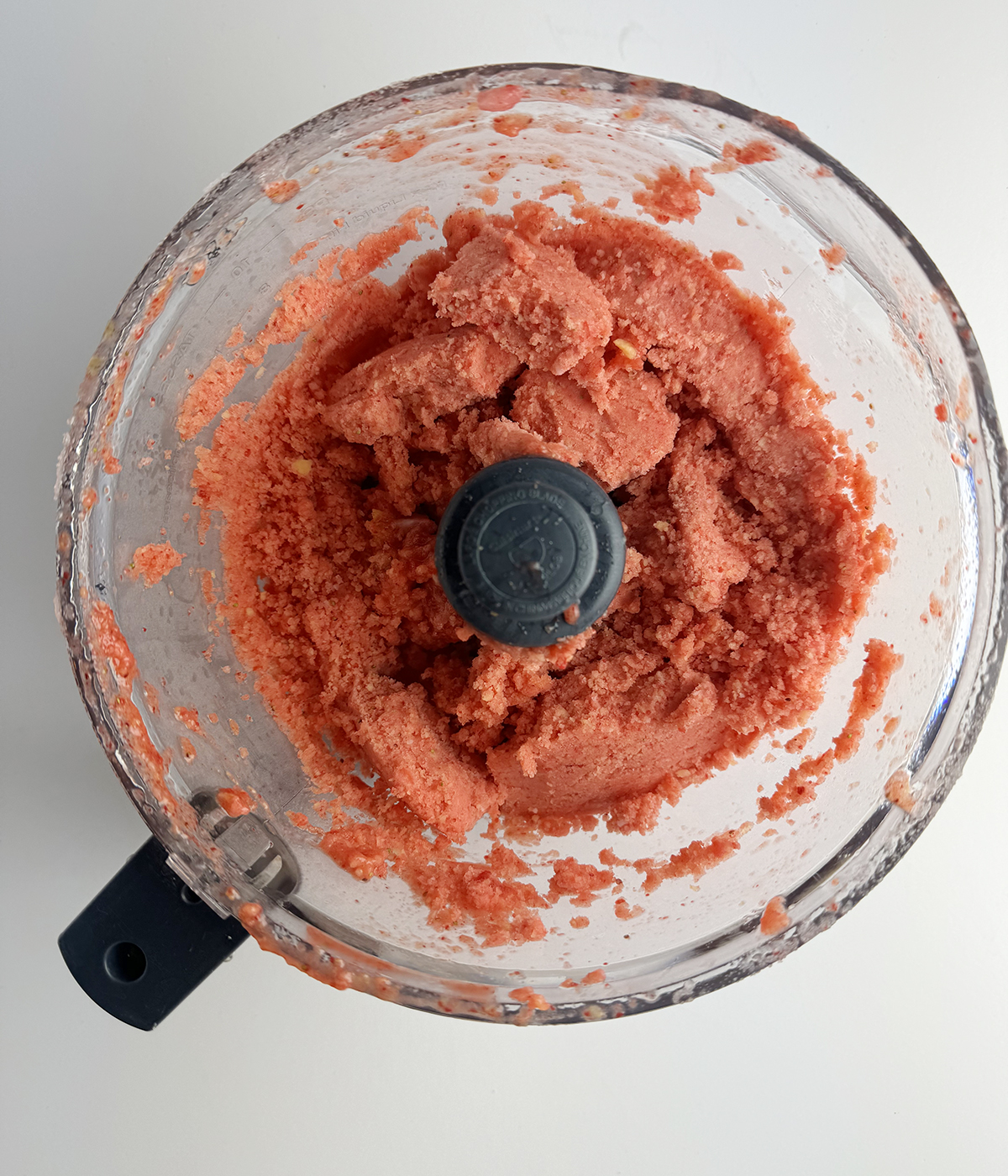 Strawberry peach sorbet in a food processor.