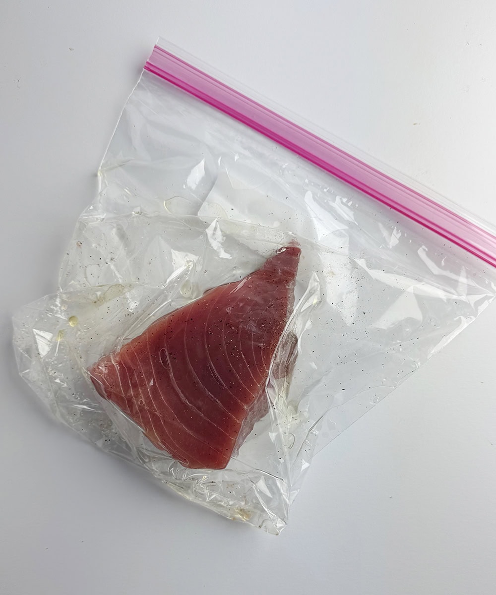 Tuna marinating in a plastic bag.