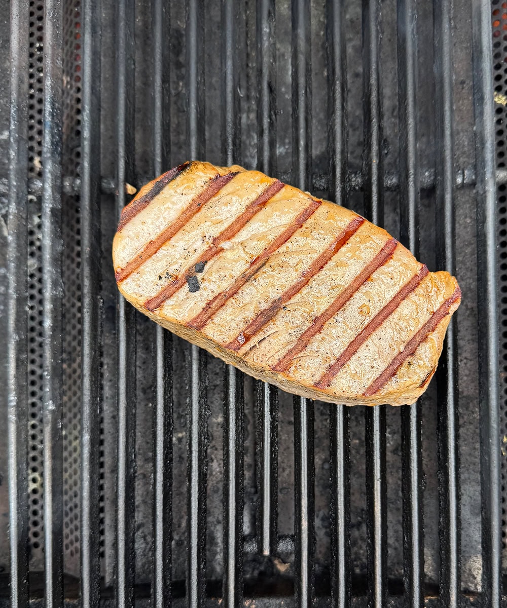 Tuna steak cooking on the grill.