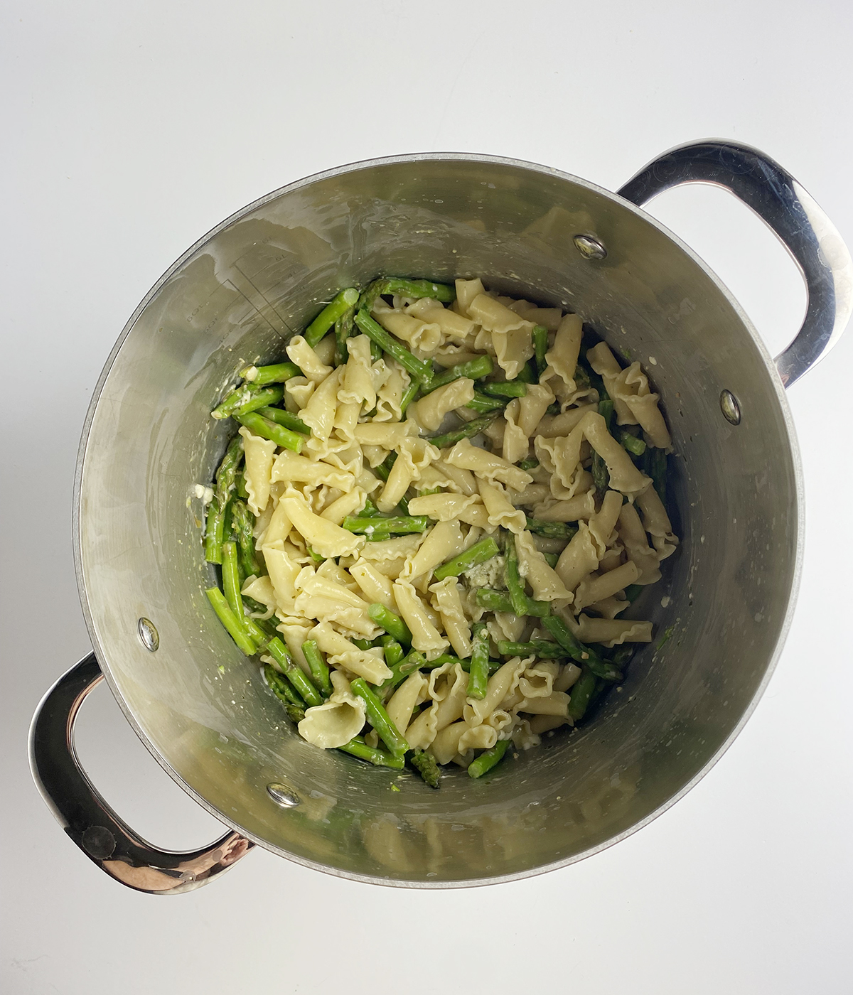 Blue cheese pesto pasta mixture in a pot.