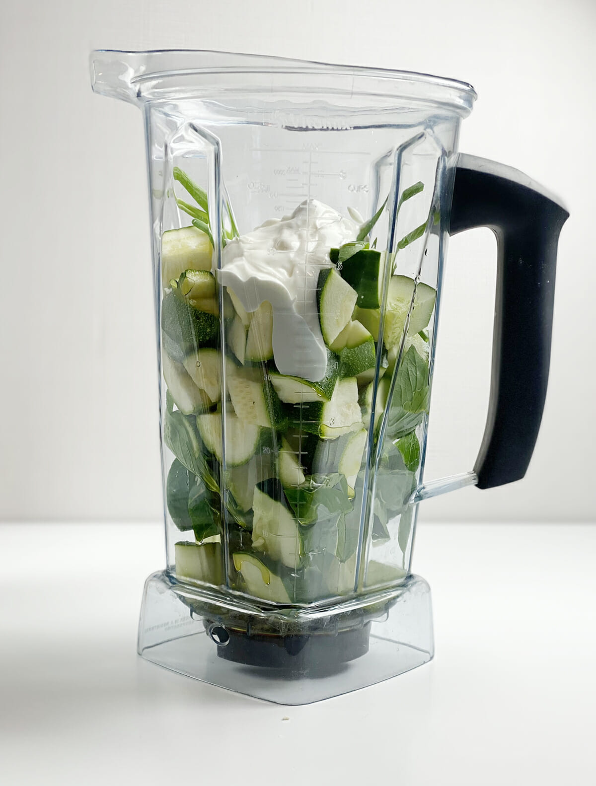 Zucchini gazpacho ingredients in a blender.