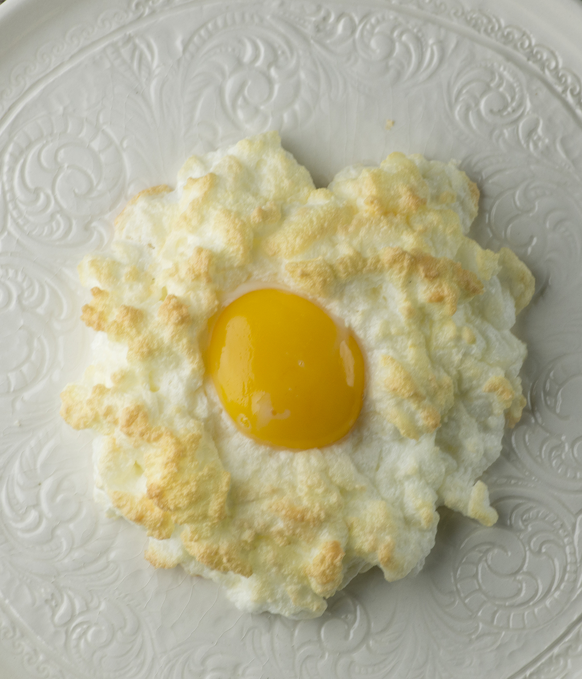 Egg in clouds on a plate.
