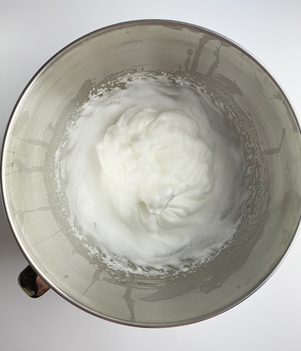 Whipped egg whites in a mixing bowl.