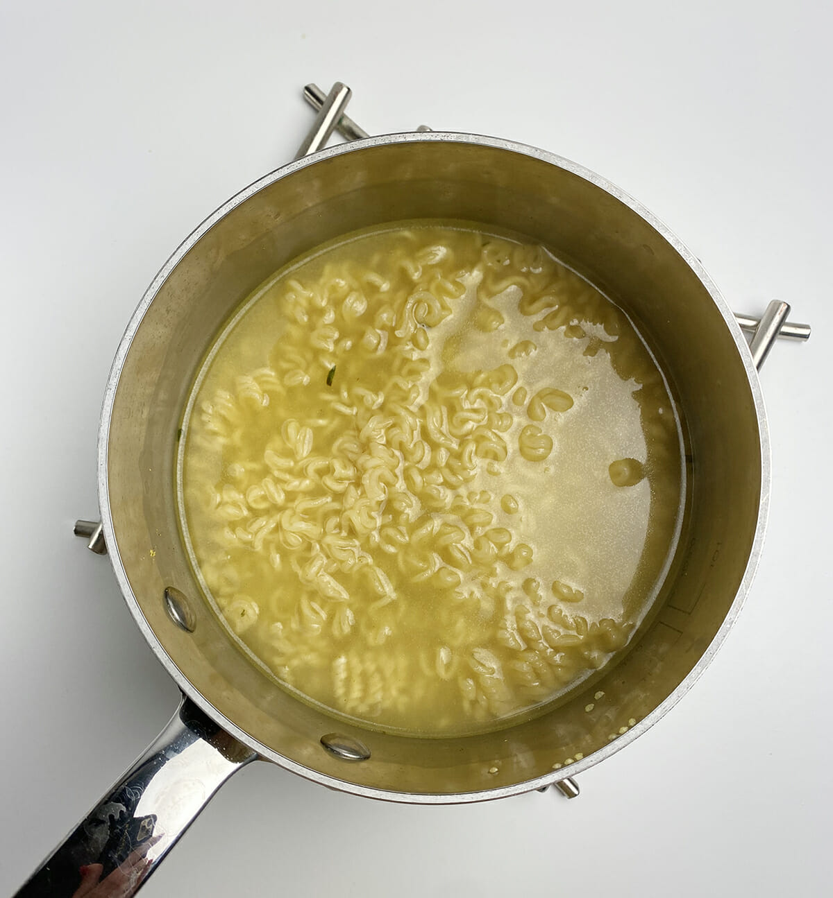 Ramen cooking in a pot.