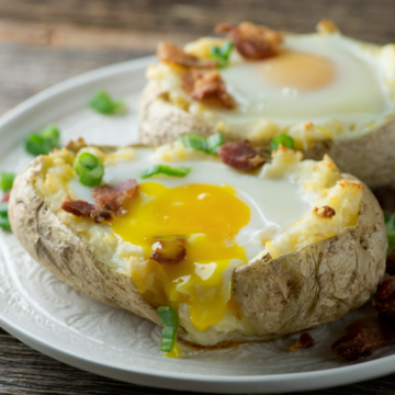 Bacon and Egg Baked Potatoes on a plate.